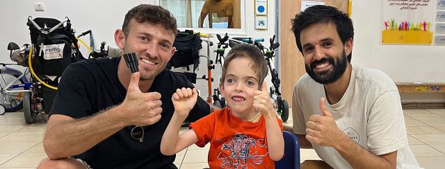איליי חסון ועמית אריאל עם עוז שלום רפפורט והכיסא שתכננו לו. צילומים: מ״ל